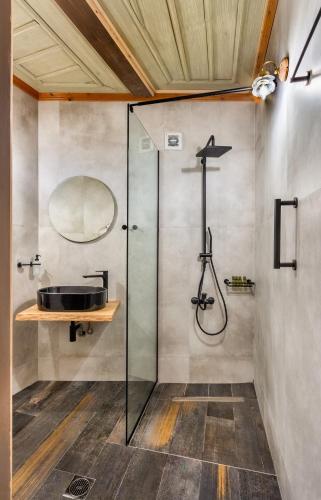 a bathroom with a glass shower and a sink at Nikos & Ioulia in Papingo