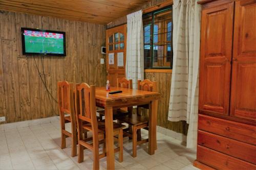 a dining room with a wooden table and chairs at Don Pepe Hotel y Cabañas in El Calafate