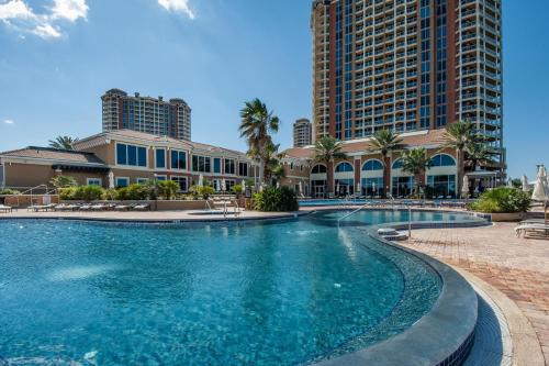 a swimming pool in front of a resort at Portofino Tower 3 Unit 1609 in Pensacola Beach