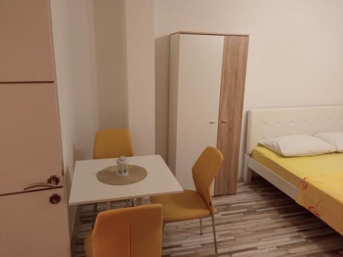 a small room with a table and chairs and a bed at Studio apartman Matković in Imotski