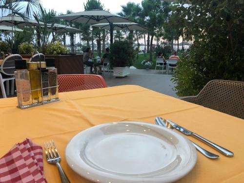 a table with a white plate and fork and knife at Villa LIDSON in Golem