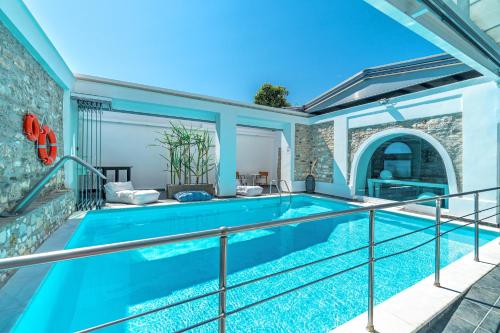 a swimming pool in a house with a brick wall at Hotel Lido Thassos in Limenas