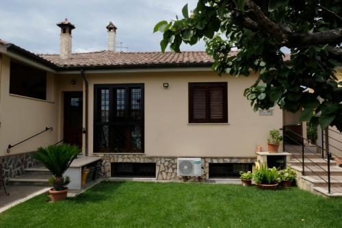 a house with a lawn in front of it at L'Albicocco in Ladispoli