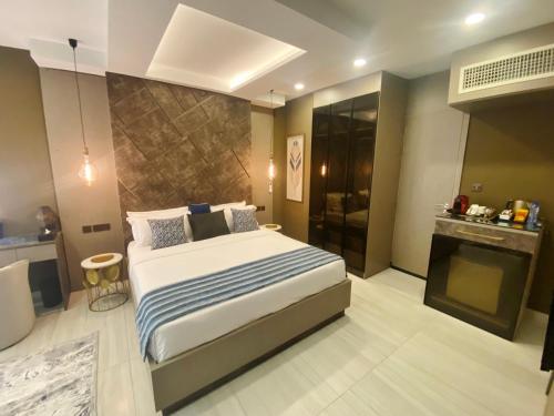 a bedroom with a large bed and a fireplace at THE POOL LABONE in Accra