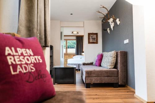 a living room with a couch and a bedroom at Chalet EDELWEISS in Ladis