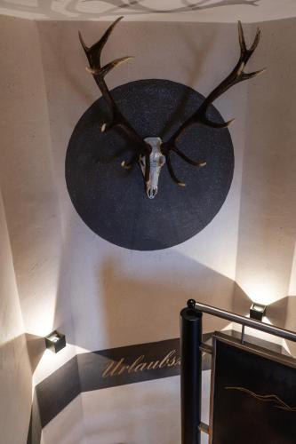a painting of a deer head on a wall at Chalet EDELWEISS in Ladis