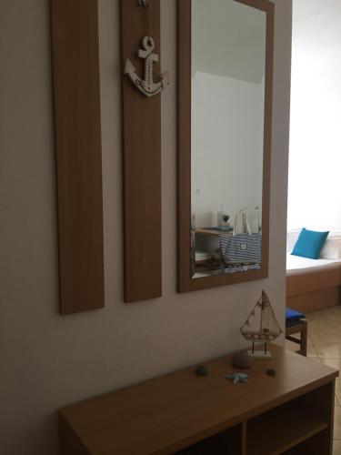 a living room with a mirror and a table at Apartments MAMPAS in Neum