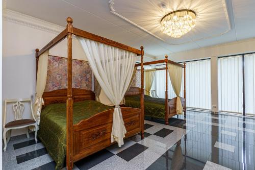 a bedroom with two beds and a chandelier at Apartments near Old Town in Tallinn