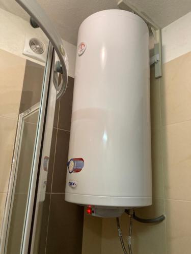 a white water tank in a shower in a bathroom at Mirabell Studio Bansko - Amazing view & fireplace in Bansko