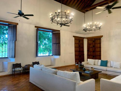 a living room with white furniture and windows at San Rafael in Mompos