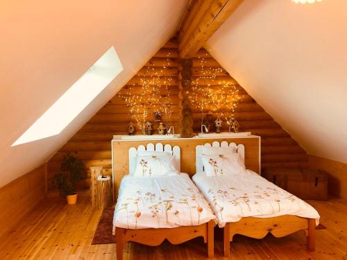PéauleにあるNeizhig Koad Petit Nid en Boisのベッドルーム(ベッド2台付)が備わる屋根裏部屋です。