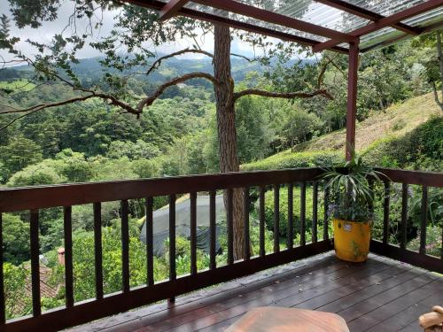a porch with a view of the mountains at Finca Paraiso Mountain Retreat near San Jose Airport in Birrí