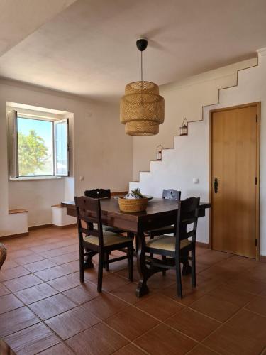 a dining room with a table and chairs and a staircase at Herdade Monte da Tapada in Alqueva
