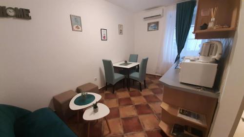 a small living room with a table and a tv at Apartment Ozana in Kotor