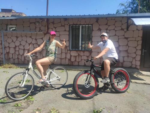 a man and a woman sitting on their bikes at Mini House in Alaverdi