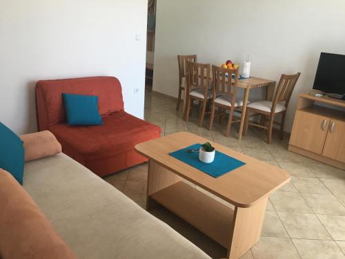 a living room with a couch and a coffee table at Apartments MAMPAS in Neum