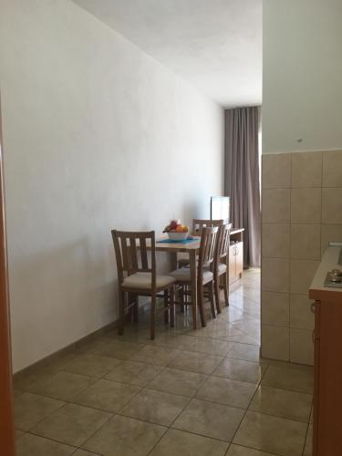 a kitchen with a table and chairs in a room at Apartments MAMPAS in Neum