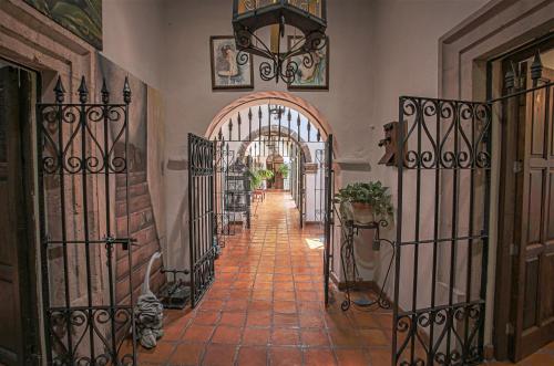 a hallway with an archway and wrought iron gates at Casa Quintana in San Miguel de Allende
