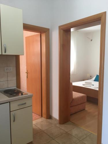 a kitchen with a door leading to a room at Apartments MAMPAS in Neum