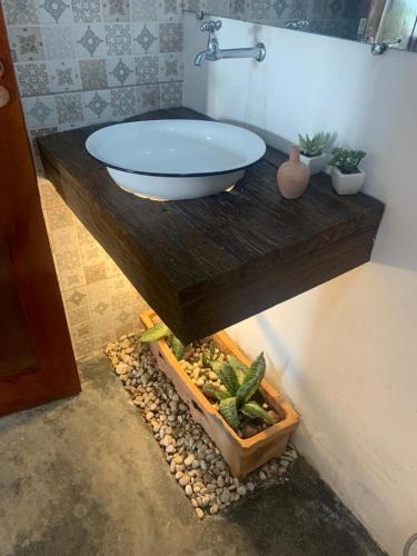 a bathroom with a sink on a wooden table at Hotel Fazenda Monte Cristo in Piranhas