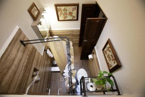 a bathroom with a staircase with a sink and a toilet at Casa Quintana in San Miguel de Allende