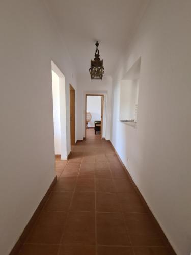 a hallway with white walls and a tile floor at Herdade Monte da Tapada in Alqueva