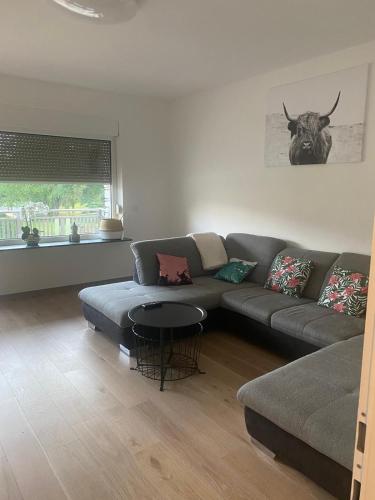 a living room with a couch and a table at Apartment mit Parkblick in Gratkorn