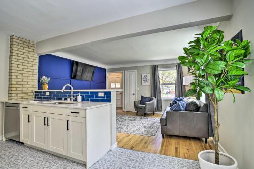 a kitchen with a sink and a living room at Cozy Home WiFi, Parking, 5 Mi to Dtwn Mpls! in Minneapolis