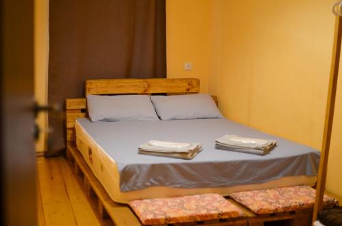 a bedroom with a bed with two towels on it at U&O Apartment, Liberty Square in Tbilisi City