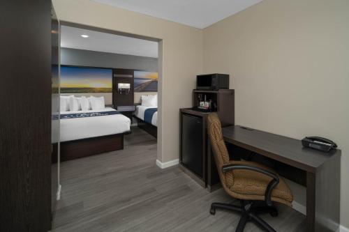 a hotel room with a desk and a bed at Days Inn by Wyndham Galt in Galt