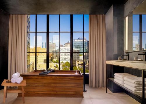 a bathroom with a tub with a view of the city at Nobu Hotel Chicago in Chicago