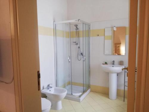 a bathroom with a shower and a toilet and a sink at Landolina Palace Hotel in Noto