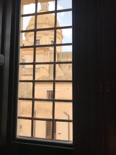a view of a building through a window at Landolina Palace Hotel in Noto