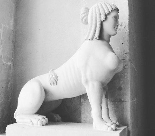 a statue of a woman sitting on a ledge at Landolina Palace Hotel in Noto