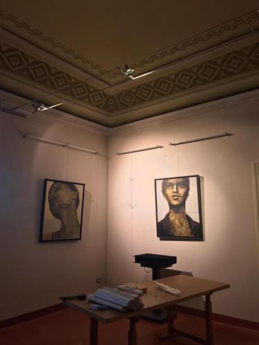 a room with a table and two pictures on the wall at Landolina Palace Hotel in Noto
