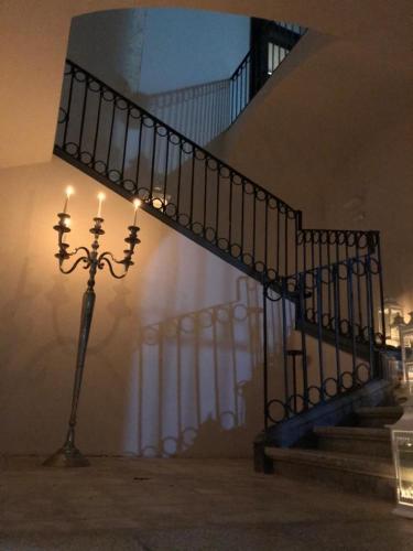a light pole next to a staircase with a stair case at Landolina Palace Hotel in Noto