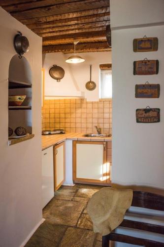 a small kitchen with white cabinets and a sink at Kytherian Harmony - Paleopolis Estate in Avlemonas