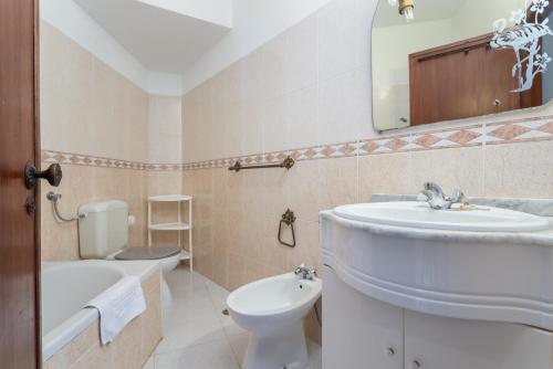 y baño con lavabo, aseo y espejo. en VILAMOURA MARINA C.A. APARTMENTS, en Vilamoura