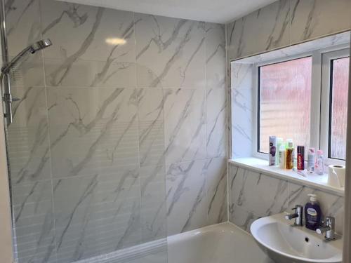 a white bathroom with a sink and a shower at Next to Liverpool Stadium in Liverpool