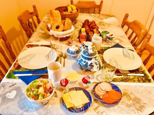 a table with plates of food on it at Treasure Box Retreat in Clifden