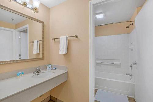 a bathroom with a sink and a shower and a mirror at Near Disney - 1 Bed King Suite - Pool and Hot Tub in Orlando