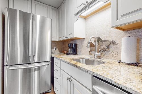 a kitchen with a stainless steel refrigerator and a sink at White Ridge B2 in Teton Village