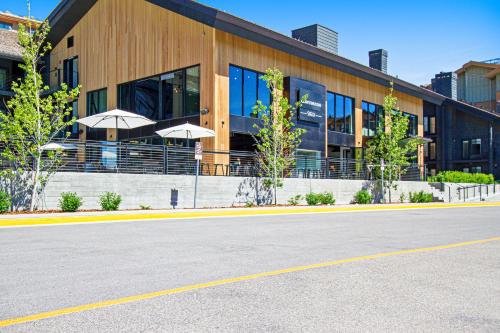 a building with umbrellas on the side of a street at White Ridge B2 in Teton Village