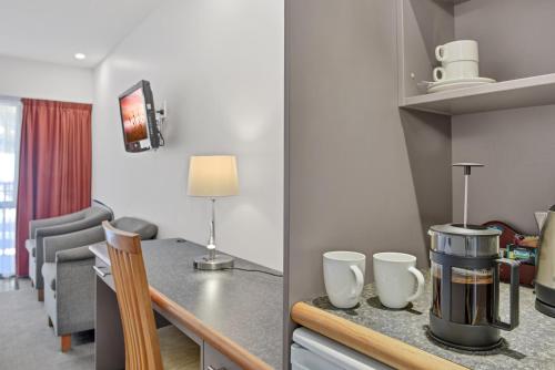 a kitchen with a coffee maker on a counter at The Hotel Nelson in Nelson