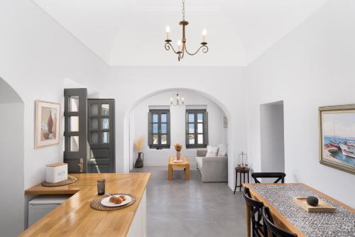 a kitchen and living room with a dining table at Kastro Mansion in Pyrgos