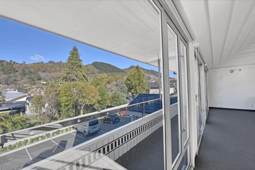 an open balcony with a view of the mountains at The Hotel Nelson in Nelson