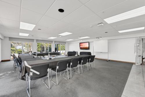 a conference room with a long table and chairs at The Hotel Nelson in Nelson