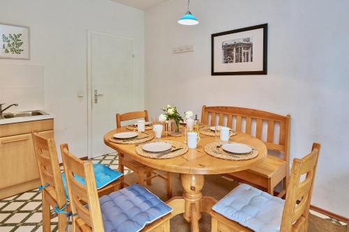 a kitchen and dining room with a wooden table and chairs at Payerbach Apartments in Payerbach