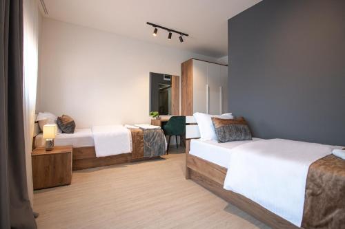 OASIS Apartments tesisinde bir odada yatak veya yataklar