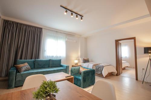 a living room with a couch and a bed at OASIS Apartments in Gevgelija